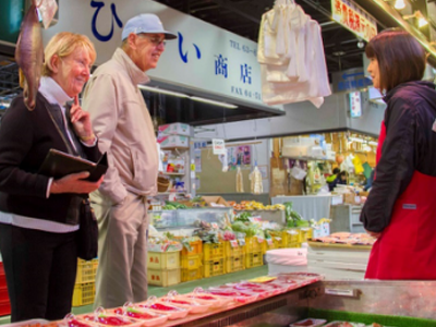 Foreign tourists looking at fresh seafood of Miyako at Fish and Vegetables Market
