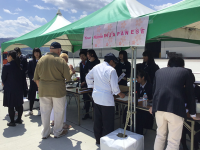 Volunteer students at the booths to welcome international guests